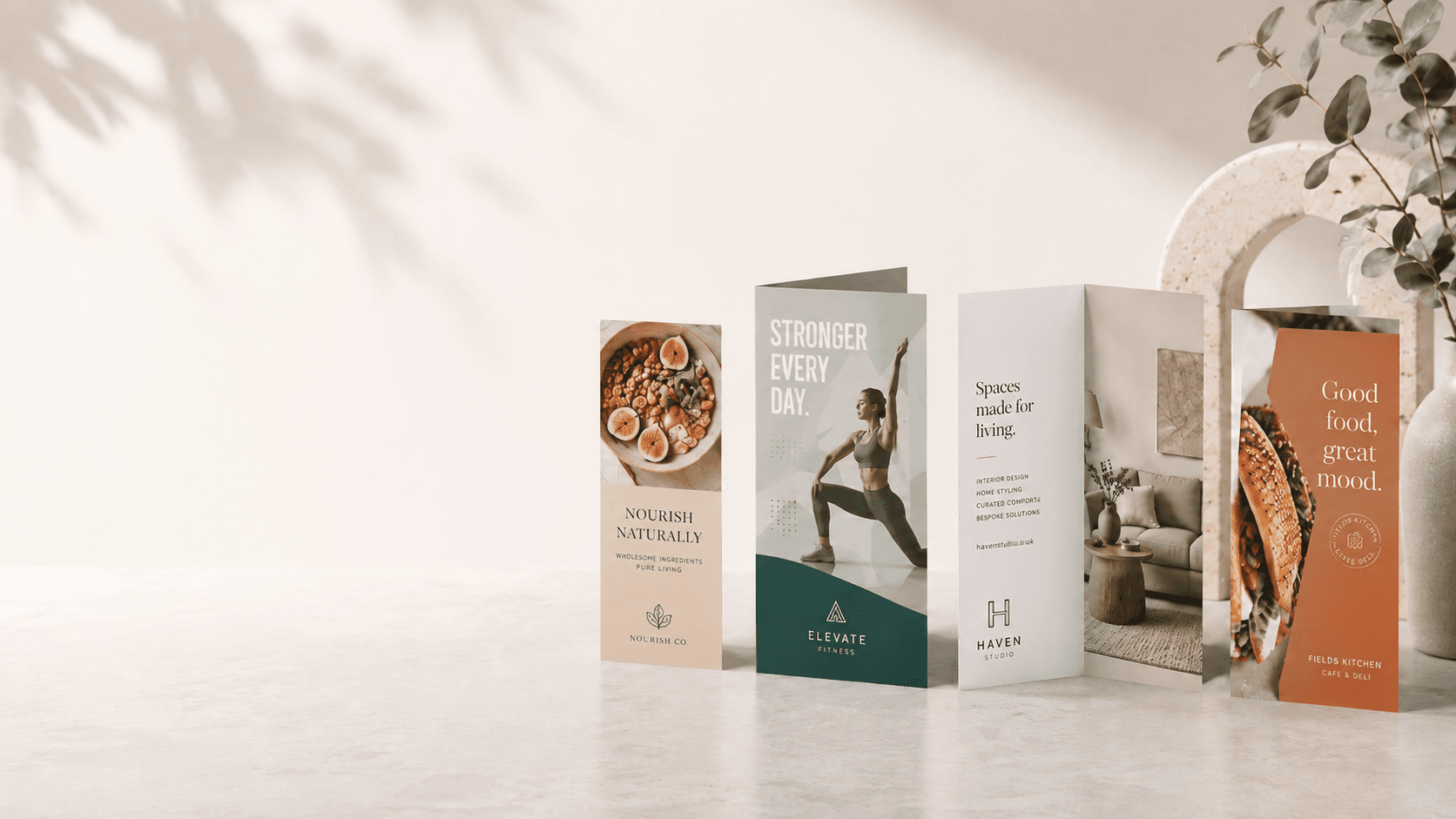 Folded leaflet print products styled in a soft studio setting